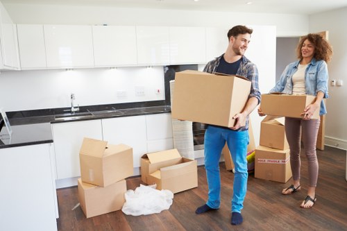 Removal staff assessing lifting risks before handling furniture