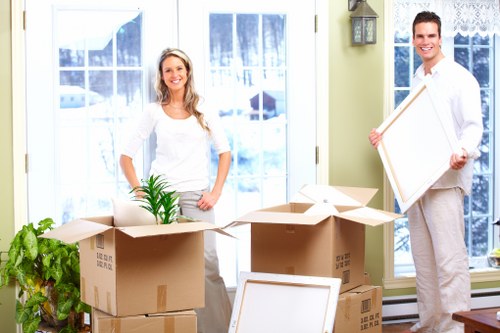 Professional movers carrying furniture during a Paddington house move