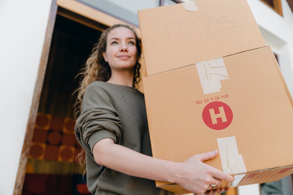 A person wearing a dark long-sleeve garment is holding a white paper card with black printed text that reads 'take what you need' and several smaller printed words such as 'love,' 'hope,' 'passion,' '